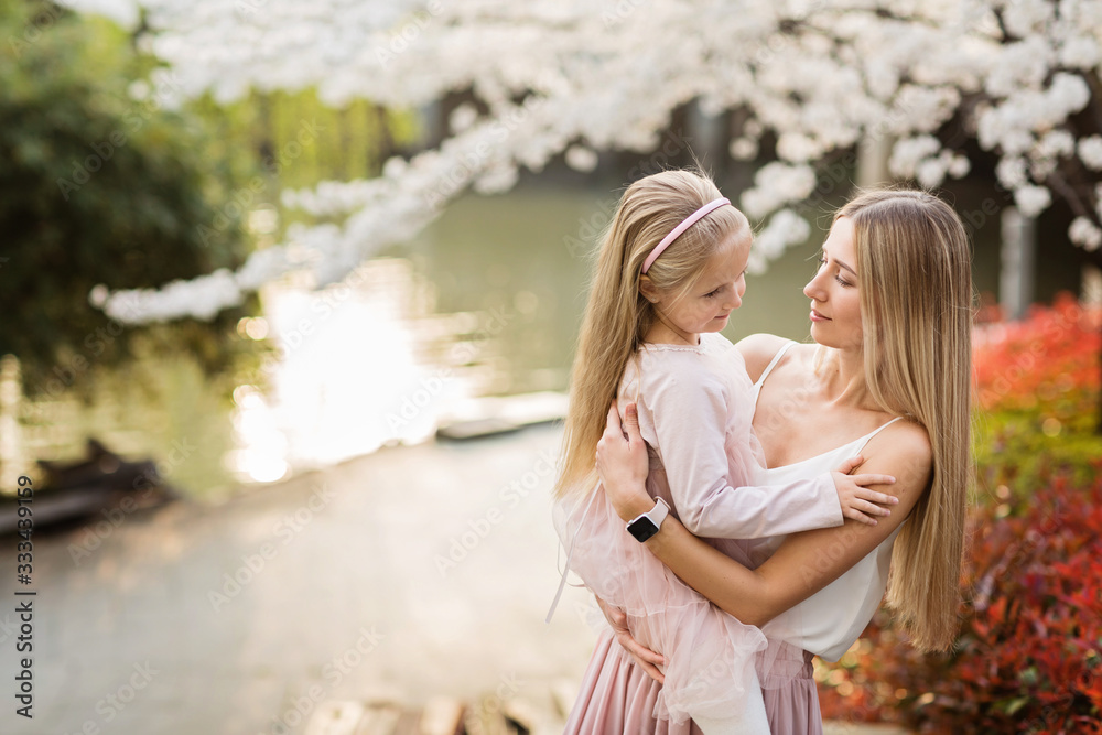 Fototapeta premium Portrait of beautiful woman and girl outdoor