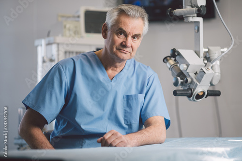 Portrait of serious surgeon that posing on camera