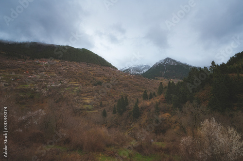 Dramatic cloudy weather on a winter day on Agrafa Mountains with snow on the peaks 