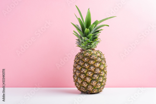 Fresh pineapple over pink background, copy space