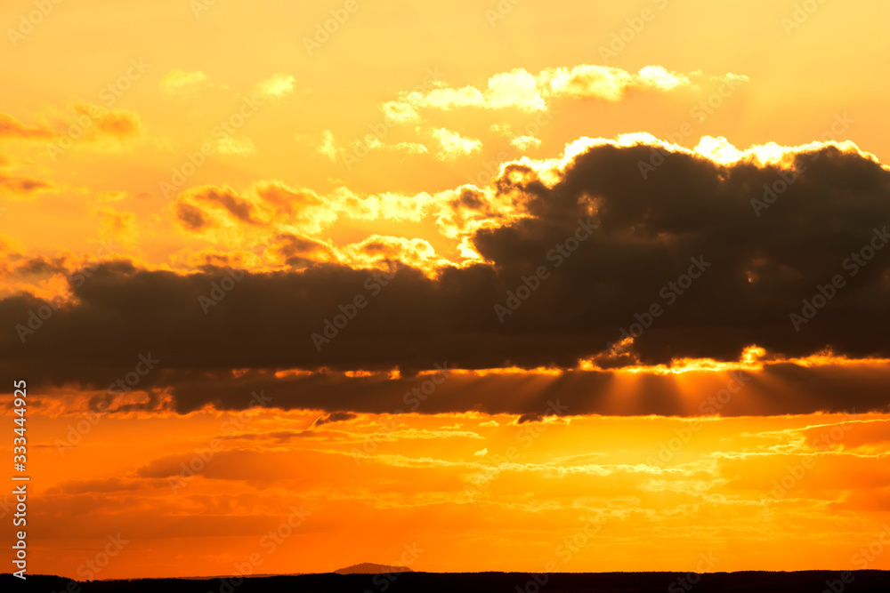 Dramatic colorful sky with clouds at sunset. Nature background.