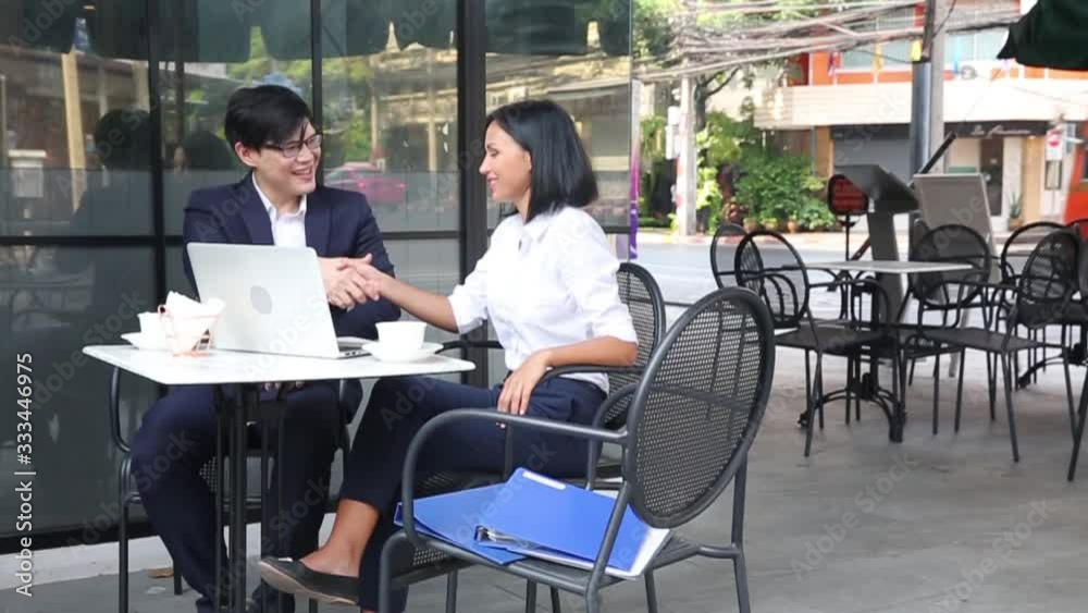 Co-working space concept. Businessmen succeed in negotiating in a coffee shop. Check hand aprove work. Co-working space concept. Businessmen succeed in negotiating in a coffee shop. Check hand aprove work.