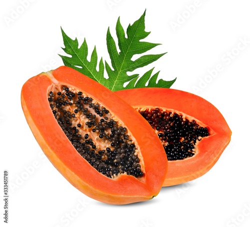 Half ripe papaya with  seeds and green leaves isolated on white background.Slices of sweet papaya isolate on white background. Full depth of field.