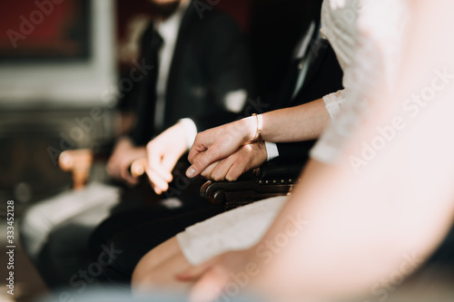 Canvas Print wedding couples hands holding at the cerenomy, sitting inside registry office