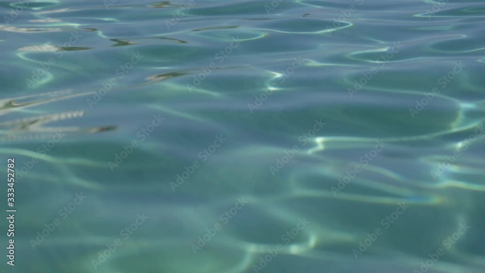 Closeup view video of beautiful blue sunny smooth waves of Aegean sea water in Greece, Halkidiki. Closeup view video of beautiful blue sunny smooth waves of Aegean sea water in Greece, Halkidiki.