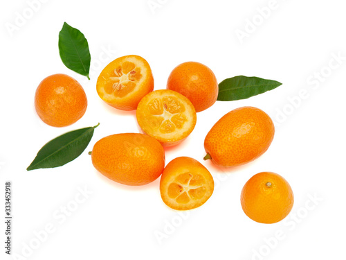 ripe kumquat fruits with green leaves, isolated on a white background