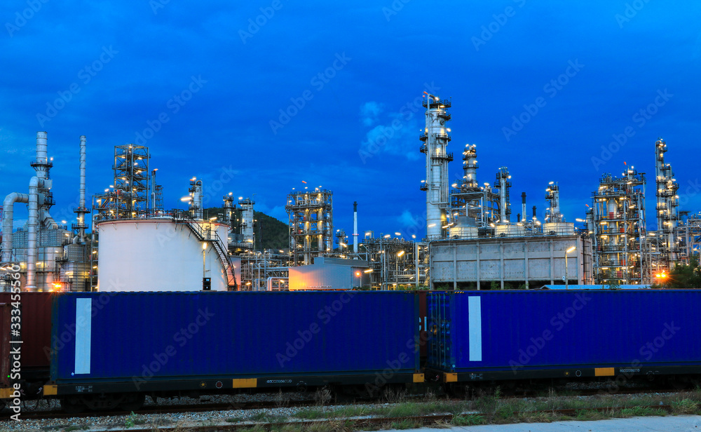 Fototapeta premium The oil refinery industry, petroleum, petrochemical plants full of technology. And the blue background, orange lights