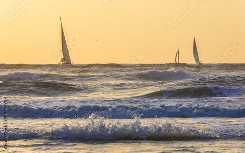 Sailboats sailing in a stor...