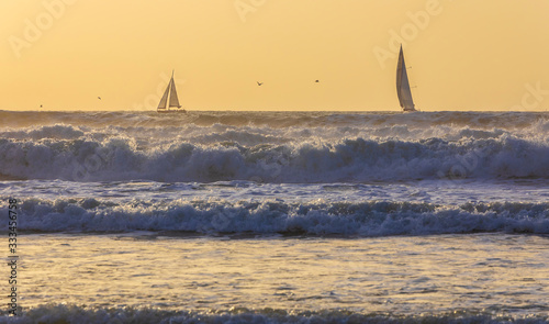 Sailboats sailing in a stor...