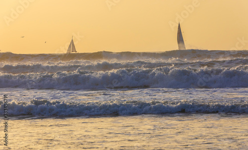 Sailboats sailing in a stor...