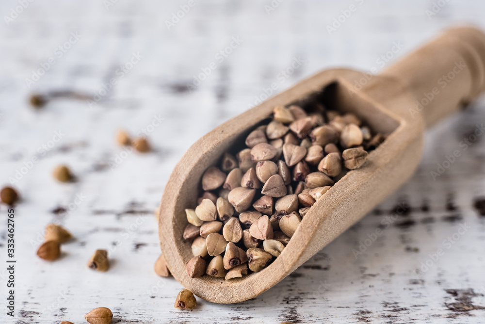 Buckwheat porridge in wooden spoons, macro photo, close-up Buckwheat porridge in wooden spoons, macro photo, close-up