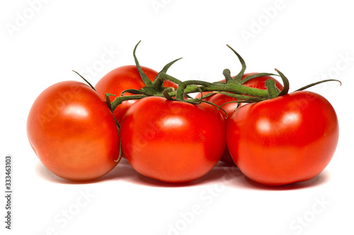 Five red tomatoes on a twig isolated on a white background