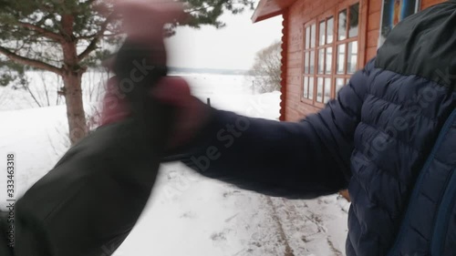 Close up view of woman's hand guesturing infront of man, explaining something. Man grabs her hand and stopping woman gesturing. Domestic violance. photo