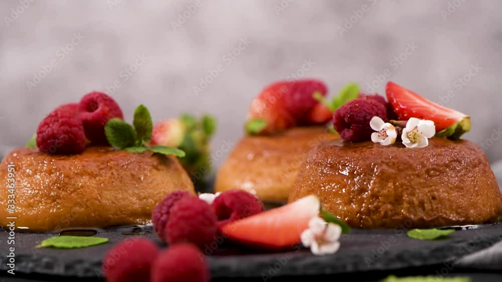 Caramel custard puddings on round slate on and dark kitchen countertop. Caramel custard puddings on round slate on and dark kitchen countertop.
