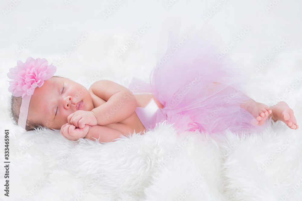 Cute newborn baby lies swaddled in a white blanket. Close up view. Cute newborn baby lies swaddled in a white blanket. Close up view.