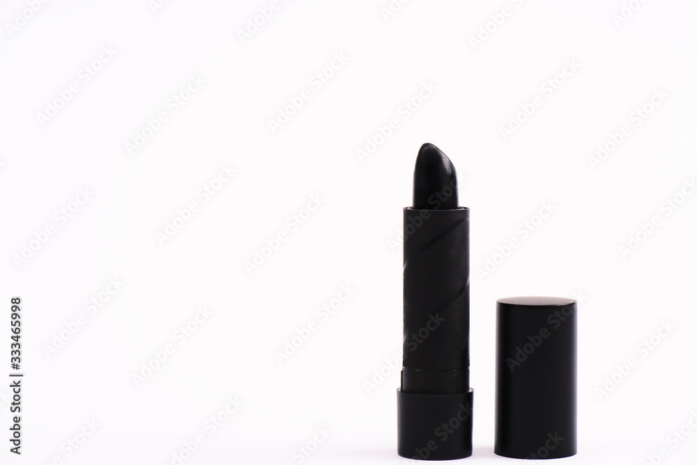 Obraz premium black lipstick on white with copy space