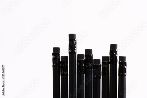 top view of black pencils with erasers isolated on white