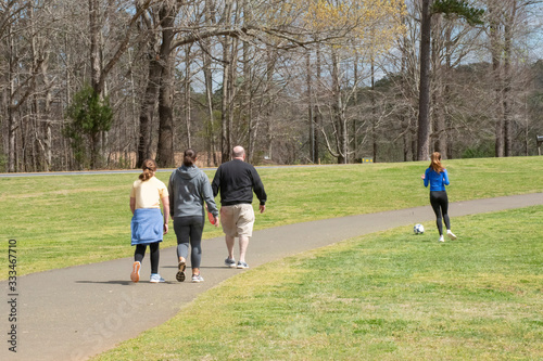 A family walking along a park trail  photo