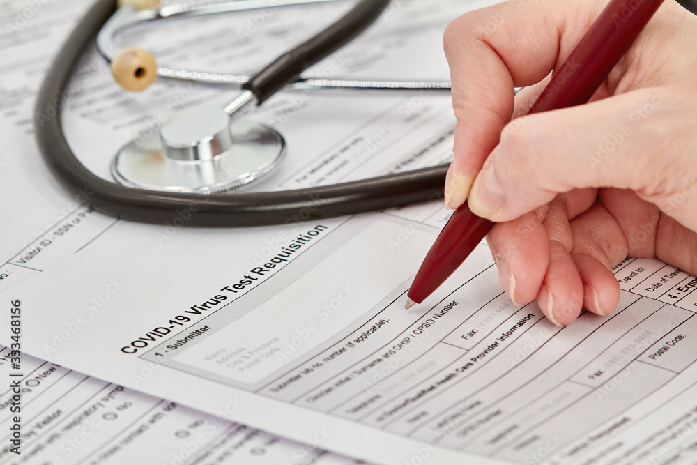 Doctor is getting ready to fill out a Virus test Requisition form. Stethoscope on the background. Closeup. Doctor is getting ready to fill out a Virus test Requisition form. Stethoscope on the background. Closeup.