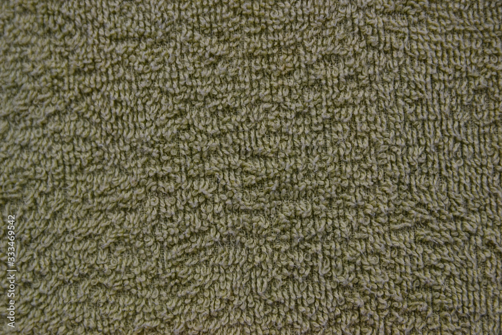 A simple example of a texture of soft, fleecy fabric, a green background. A simple example of a texture of soft, fleecy fabric, a green background.