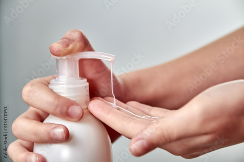 Girl hands using hand sanitizer or liquid soap. Viral Disease Prevention