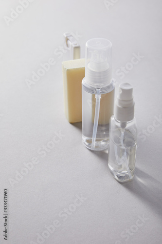 hand sanitizer in spray bottles and antibacterial soap on white background