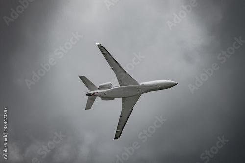 Airplane in the sky - cloudy day. Dramatic cloudy sky.