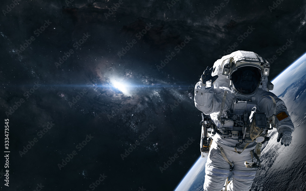 Fototapeta premium Astronaut on the background of a bright star in the center of the galaxy. Deep space planet. Science fiction. Elements of this image furnished by NASA