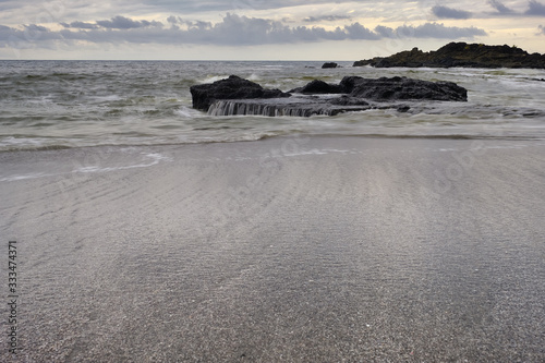 Black Sand beach and rocks of Playa Cocal on the Pacific coast of Costa Rica photo