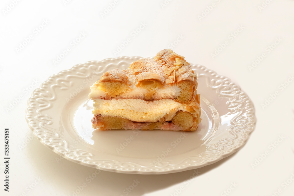 Dessert - sponge cake with vanilla filling on decorative white plate Dessert - sponge cake with vanilla filling on decorative white plate