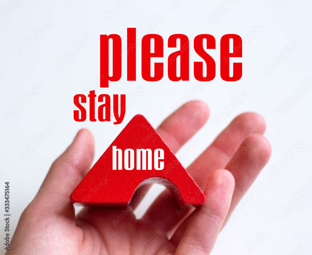 hand on a white background holds a red roof please stay home photo with text hand on a white background holds a red roof please stay home photo with text