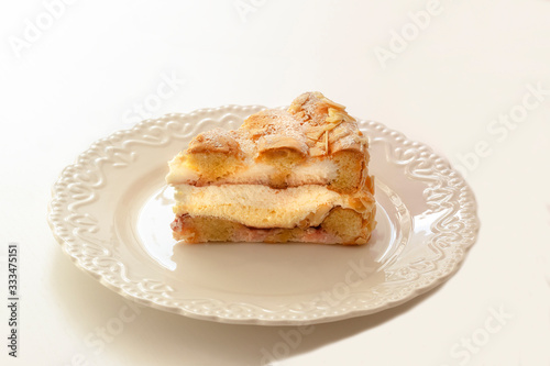 Dessert - sponge cake with vanilla filling on decorative white plate