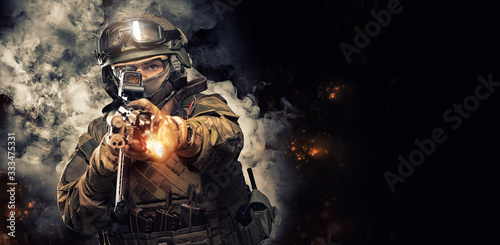 Portrait of a special forces soldier who is aiming at a collimator sight of a machine gun. The concept of special military units. Computer games. photo