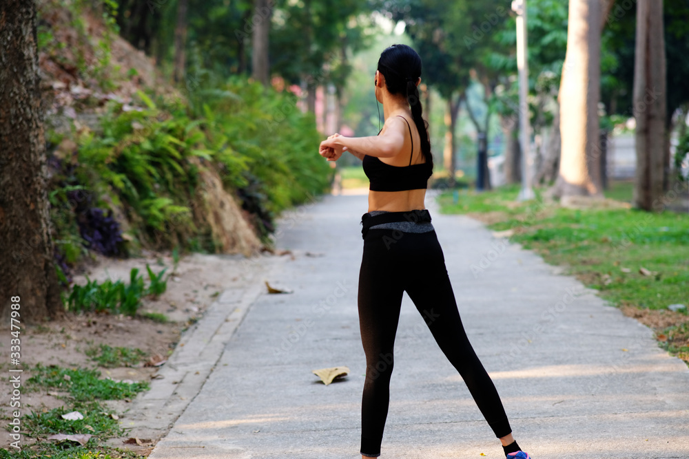 young woman doing running exercises in the park