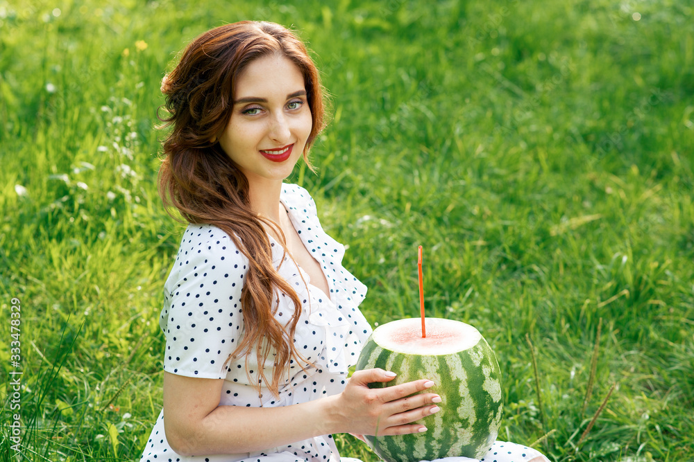 Fototapeta premium Woman with watermelon on grass.