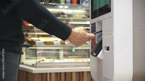 a young man buys a telephone in a contactless way in a self-service machine. men pay by phone. close up. 4k Video 