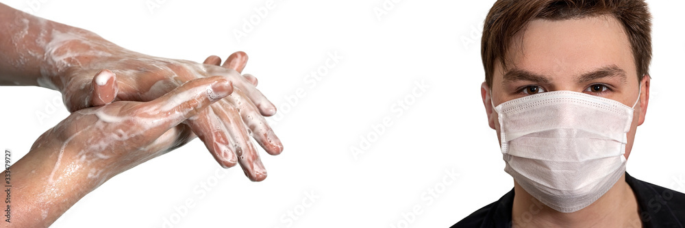 Corona virus. Young guy in a medical protective mask and washing his hands with soap on a white background. Protection against viruses, infections. Corona virus. Young guy in a medical protective mask and washing his hands with soap on a white background. Protection against viruses, infections.