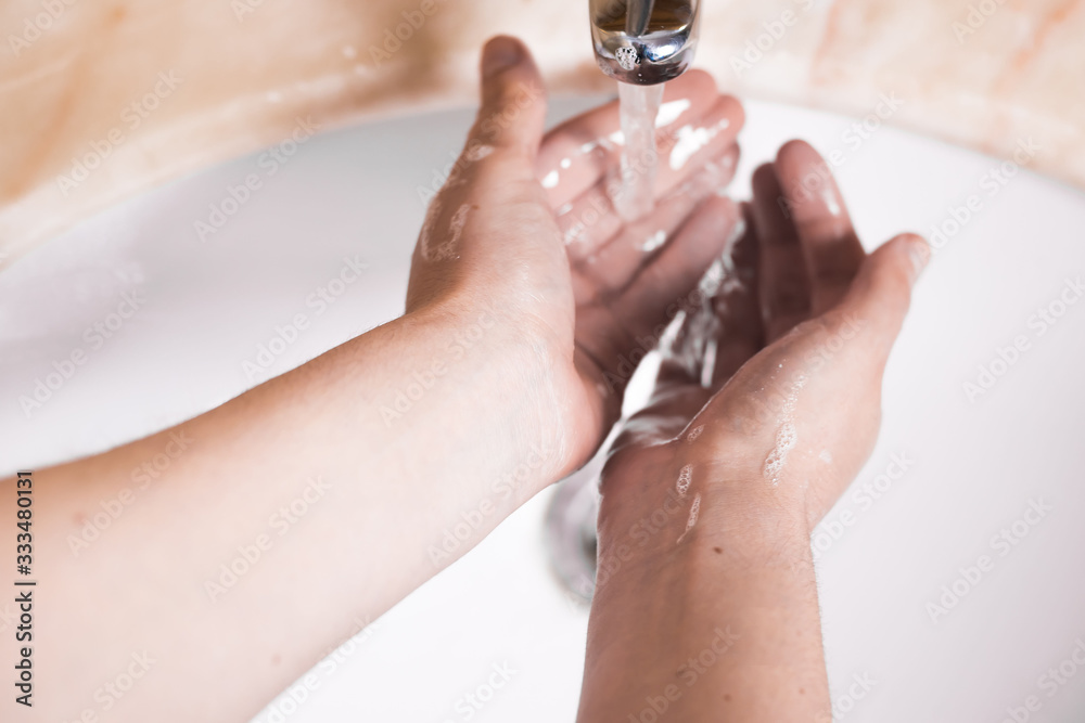 Fototapeta premium woman washing hands in bathroom