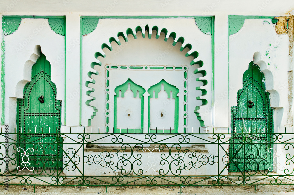 Green doors on white wall in Chef Chaouen, Morocco
