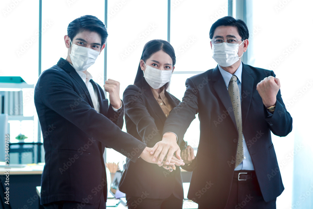 Asian business people in suit wearing face mask to protect himselves ...