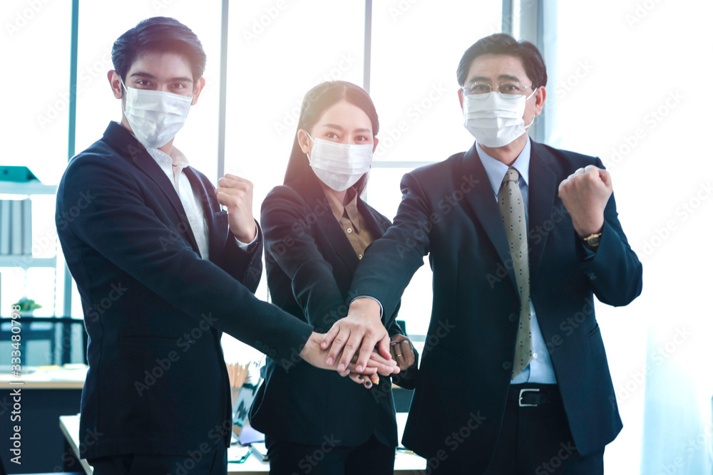Asian business people in suit wearing face mask to protect himselves ...