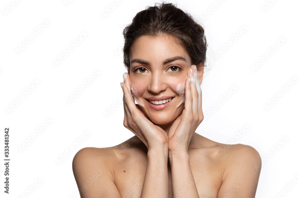 Nice woman with facial foaming cleanser looking at camera enjoys applying perfect fresh clean skincare cosmetics. Nice woman with facial foaming cleanser looking at camera enjoys applying perfect fresh clean skincare cosmetics.