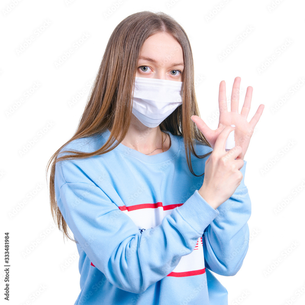 Woman in medical protective mask holding antiseptic disinfection virus on white background isolation Woman in medical protective mask holding antiseptic disinfection virus on white background isolation