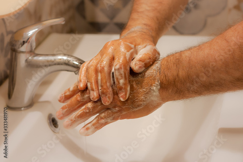 Washing hands frequently with soap and hot water for coronavirus outbreak prevention. Hygiene of hands for covid-19 pandemic protection.