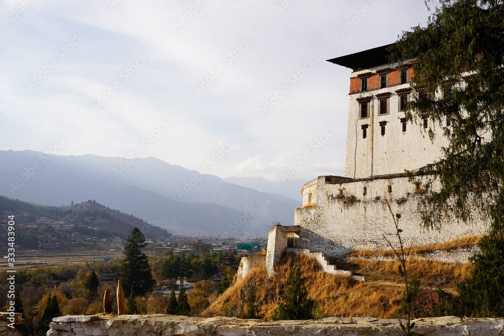 A wall of the Paro Dzong and the landscape of the Paro valley, Bhutan 