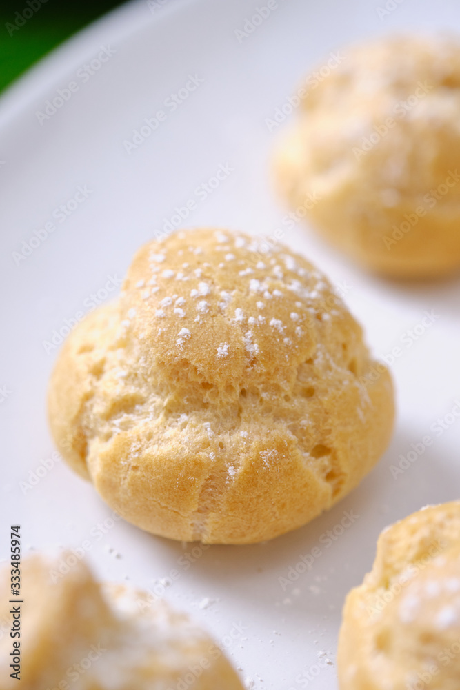 choux cream or cream puff or French profiteroles with fresh cream set on cafe table. choux cream or cream puff or French profiteroles with fresh cream set on cafe table.