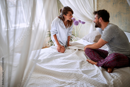 Woman and man enjoying in bedroom