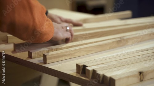 Carpenter sorting wooden laths