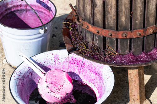  Wine making. Technology of wine production in Moldova. The ancient folk tradition of grape processing. The squeezer is used to press the wine. photo