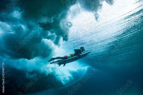 Surfer duck diving photo